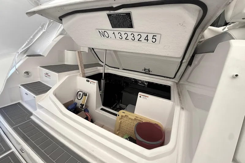Slide: The Image of 2022 Regal 38 XO boat storage compartment with open hatch and equipment inside. - 5
