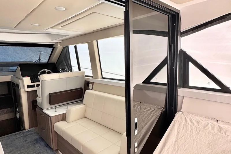 Slide: The Image of Interior of 2022 Regal 38 XO yacht with modern seating and helm. - 7