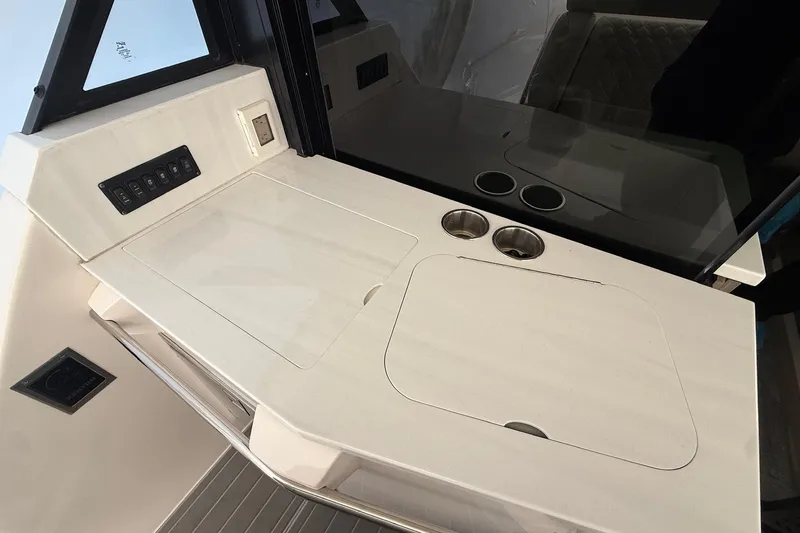 Slide: The Image of 2022 Regal 38 XO yacht interior with sleek countertop and control panel. - 8