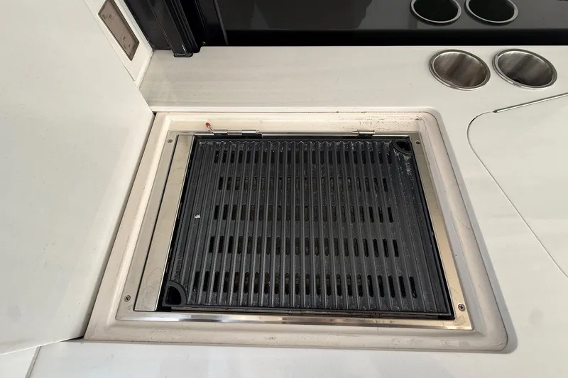 Slide: The Image of Built-in grill on 2022 Regal 38 XO yacht's sleek kitchen counter. - 9
