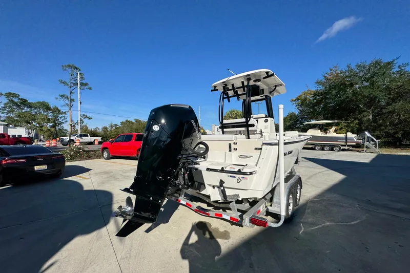 Slide: The Image of 2026 Sea Born LX231 Center Console boat on trailer in sunny outdoor setting. - 13