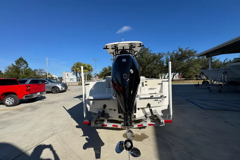 Slide: The Image of 2026 Sea Born LX231 Center Console boat with powerful outboard motor in a sunny parking lot. - 14