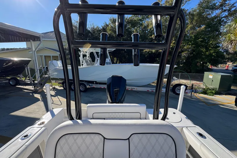 Slide: The Image of 2026 Sea Born LX231 Center Console boat at a marina, rear view. - 28
