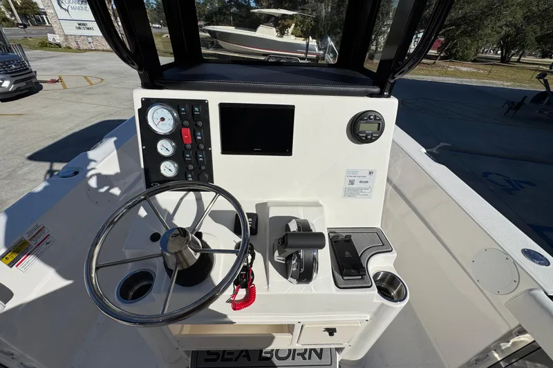 Slide: The Image of 2026 Sea Born LX231 Center Console boat dashboard with steering wheel and controls. - 30