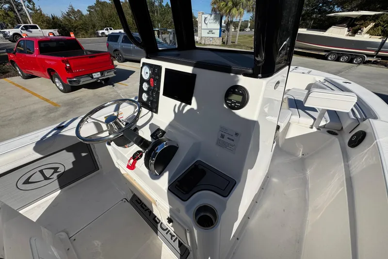 Slide: The Image of 2026 Sea Born LX231 Center Console boat interior with steering wheel and control panel. - 32