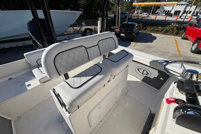 Slide: The Image of 2026 Sea Born LX231 Center Console boat interior with cushioned seating and steering wheel. - 33
