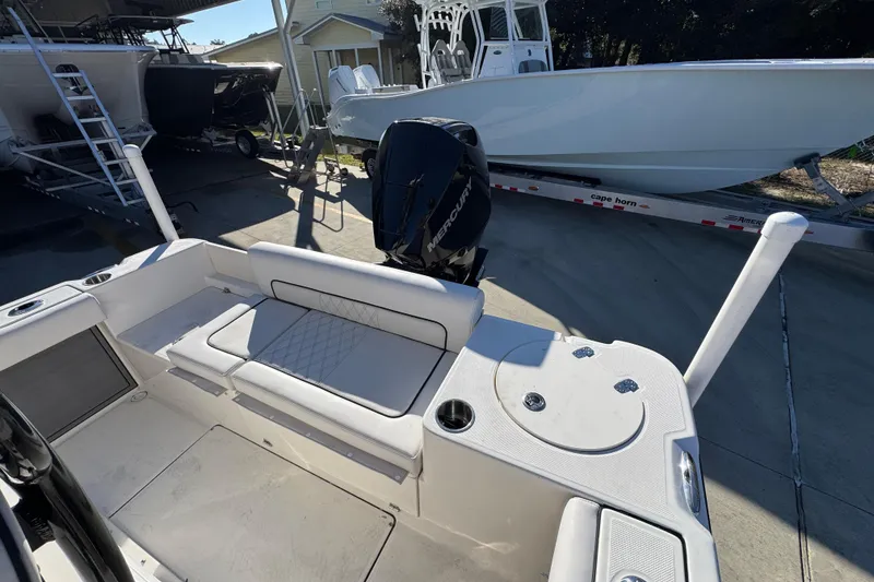 Slide: The Image of 2026 Sea Born LX231 Center Console boat with Mercury engine, docked outdoors. - 35