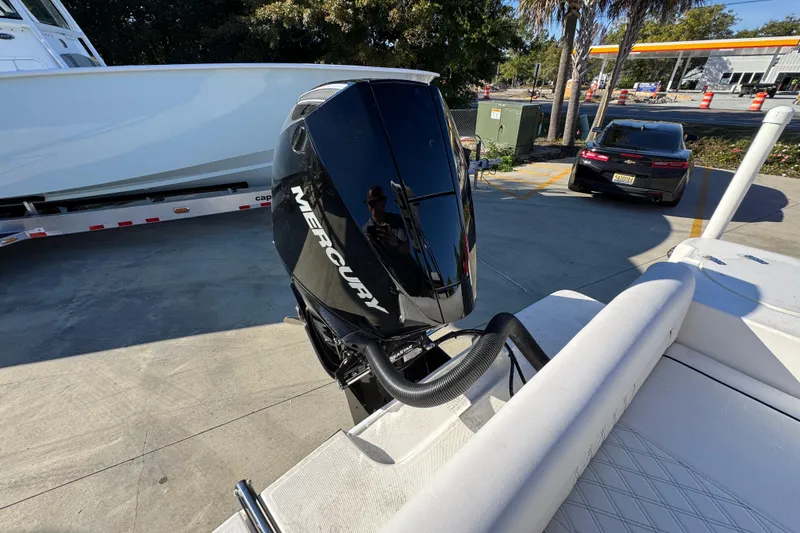 Slide: The Image of 2026 Sea Born LX231 Center Console with Mercury outboard engine at a marina. - 38