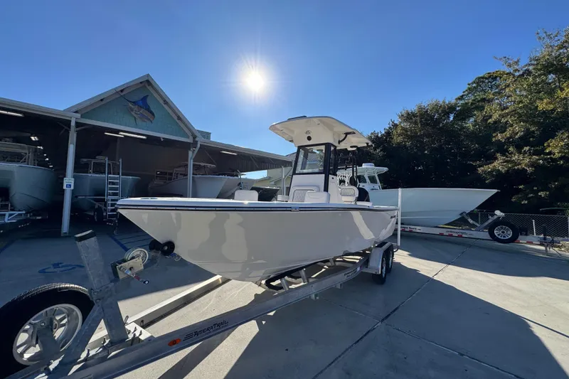 Slide: The Image of 2026 Sea Born LX231 Center Console boat on trailer under clear blue sky. - 4