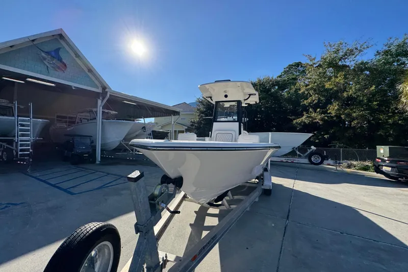 Slide: The Image of 2026 Sea Born LX231 Center Console boat on trailer under sunny sky. - 5