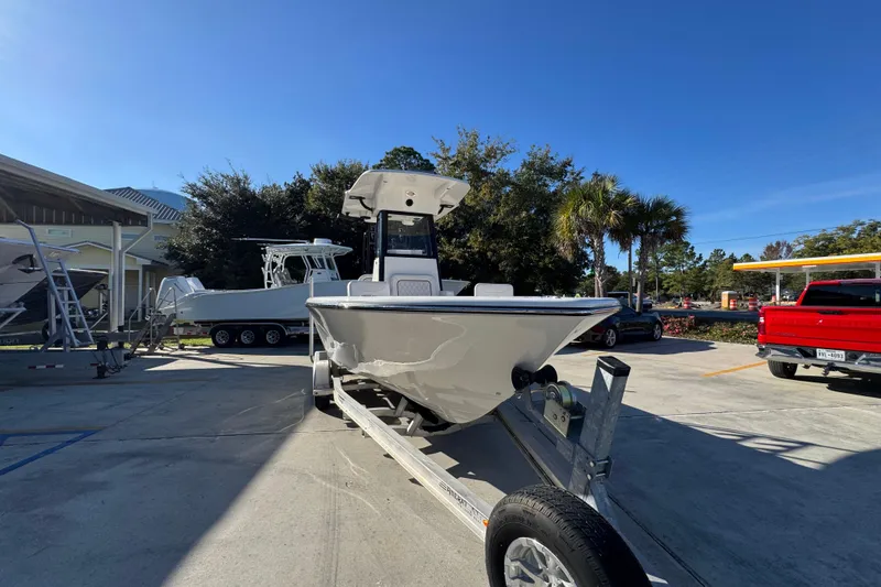 Slide: The Image of 2026 Sea Born LX231 Center Console boat on trailer in sunny outdoor setting. - 7