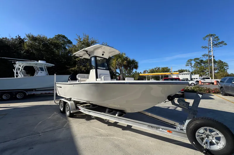 Slide: The Image of 2026 Sea Born LX231 Center Console boat on trailer in sunny outdoor setting. - 8