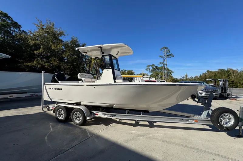Slide: The Image of 2026 Sea Born LX231 Center Console boat on trailer, parked outdoors. - 9