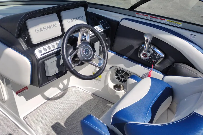 Slide: The Image of 2026 Crownline 260 XSS boat cockpit with Garmin displays and blue-white seating. - 12
