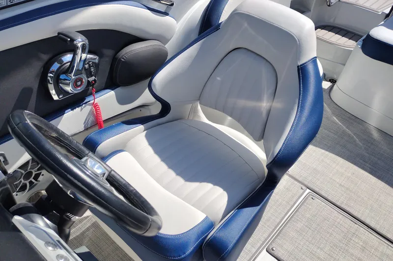 Slide: The Image of 2026 Crownline 260 XSS boat interior with steering wheel and captain's seat. - 16