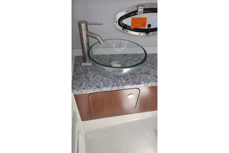 Slide: The Image of Modern glass sink and faucet on granite countertop in 2026 Crownline 260 XSS boat. - 18