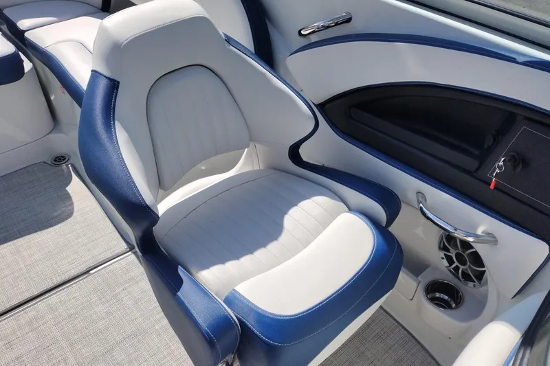 Slide: The Image of 2026 Crownline 260 XSS boat interior with blue and white seating and modern controls. - 20