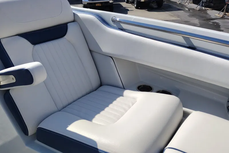 Slide: The Image of 2026 Crownline 260 XSS boat interior with white and blue seating, cup holders visible. - 30