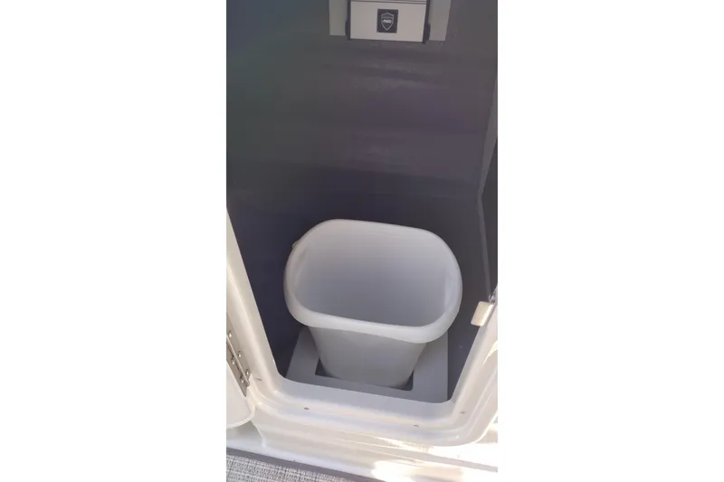 Slide: The Image of Trash bin compartment in 2026 Crownline 260 XSS boat interior. - 31