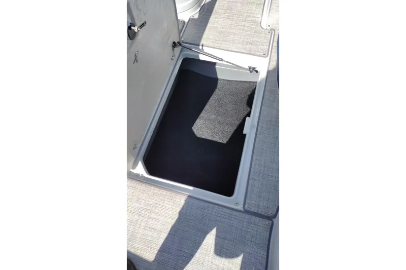 Slide: The Image of Open storage compartment on 2026 Crownline 260 XSS boat deck. - 34