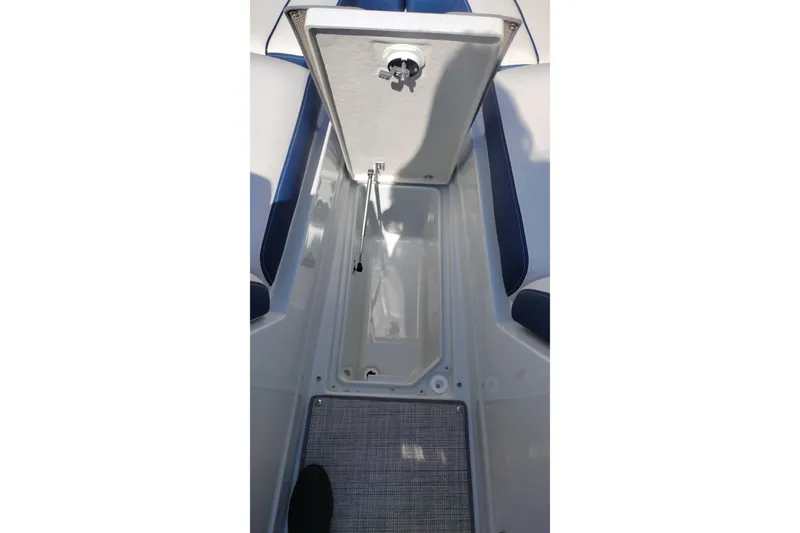 Slide: The Image of Open storage compartment on 2026 Crownline 260 XSS boat, showcasing interior space. - 35