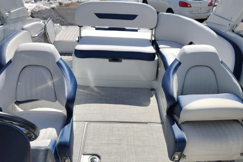 Slide: The Image of Interior of 2026 Crownline 260 XSS boat with blue and white seating. - 36