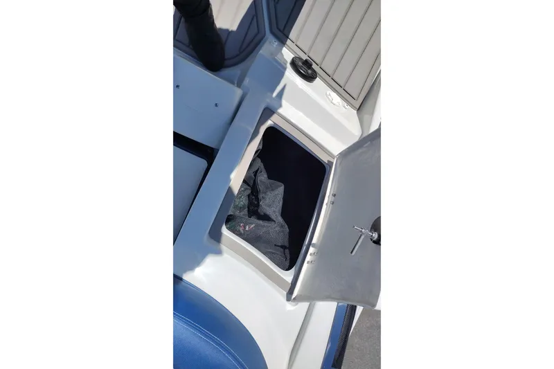 Slide: The Image of Open storage compartment on 2026 Crownline 260 XSS boat deck. - 41