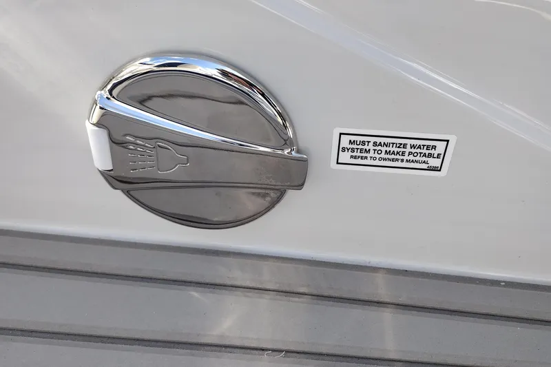 Slide: The Image of 2026 Crownline 260 XSS boat water system sanitization warning label and chrome shower cap. - 42