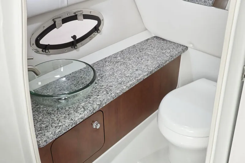 Slide: The Image of Luxurious bathroom in 2026 Crownline 260 XSS boat with granite countertop and glass sink. - 8