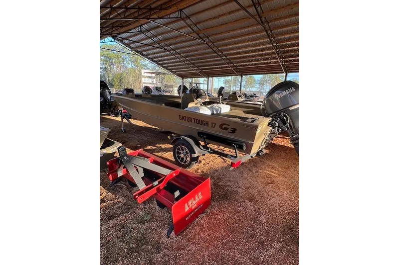 The Image of 2026 G3 Gator Tough 17 SC boat under a metal canopy, with Yamaha engine. - 1