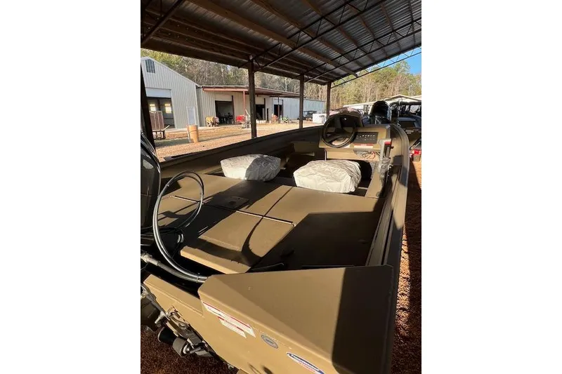 Slide: The Image of 2026 G3 Gator Tough 17 SC boat under a metal canopy, showcasing interior and steering. - 3