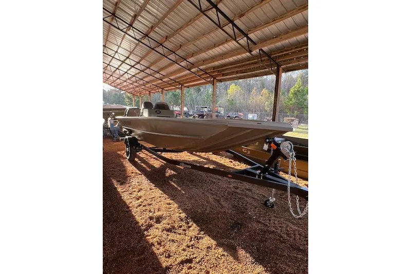 Slide: The Image of 2026 G3 Gator Tough 17 SC boat under a metal canopy, on a trailer. - 6