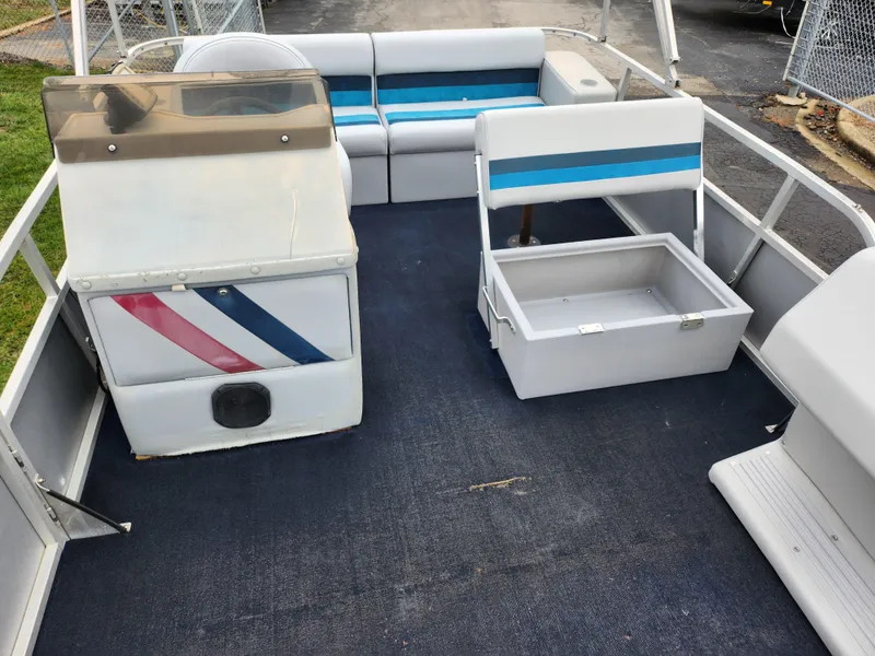 Slide: The Image of 1991 Grumman Fish N Fun 20' pontoon boat interior with seating and storage. - 11
