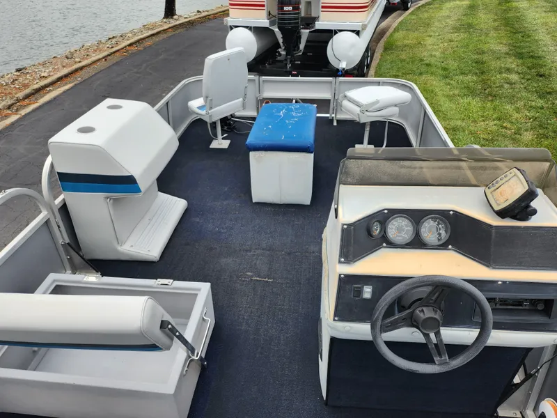 Slide: The Image of 1991 Grumman Fish N Fun boat interior with seating and steering console. - 15