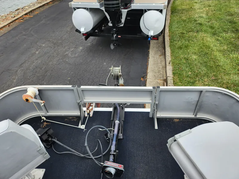 Slide: The Image of 1991 Grumman Fish N Fun boat on trailer, parked on a paved road. - 19