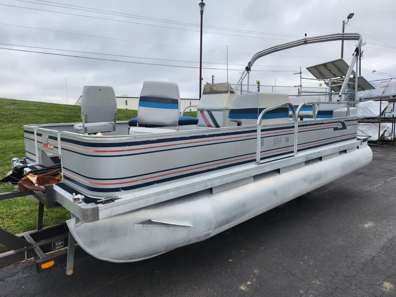 Slide: The Image of 1991 Grumman Fish N Fun 20' pontoon boat on trailer, gray with blue accents. - 5