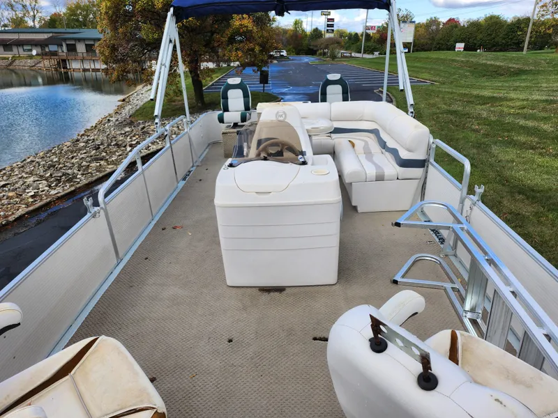 Slide: The Image of 2002 Harris FloteBote 220 Fisherman pontoon boat with spacious seating and scenic lake view. - 11
