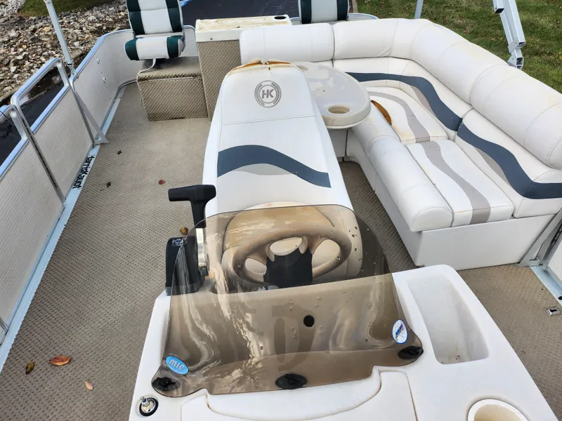 Slide: The Image of 2002 Harris FloteBote 220 Fisherman interior with steering console and cushioned seating. - 13