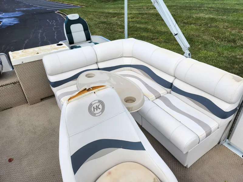 Slide: The Image of 2002 Harris FloteBote 220 Fisherman boat interior with white and blue seating. - 14