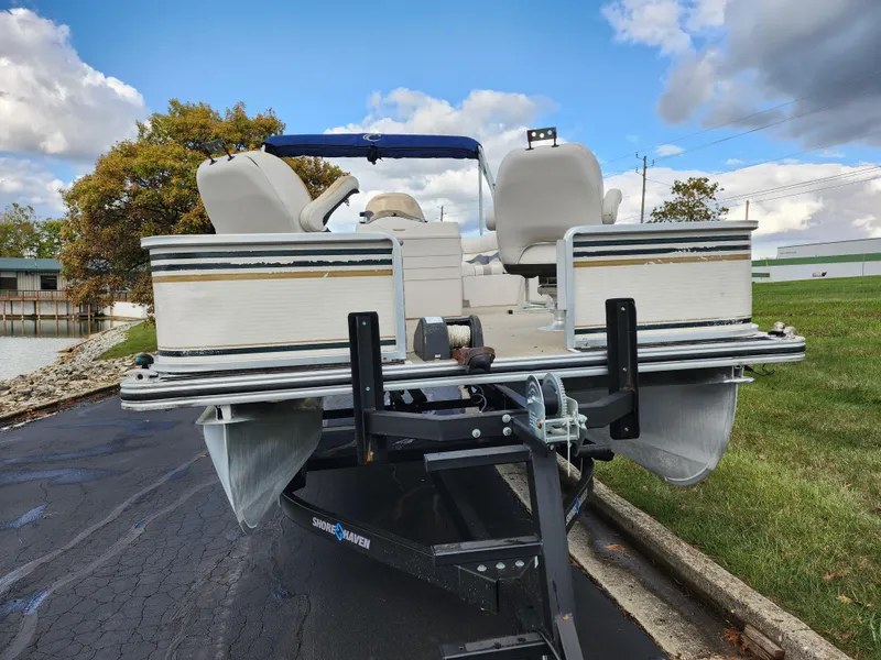 Slide: The Image of 2002 Harris FloteBote 220 Fisherman pontoon boat on trailer, parked outdoors. - 6