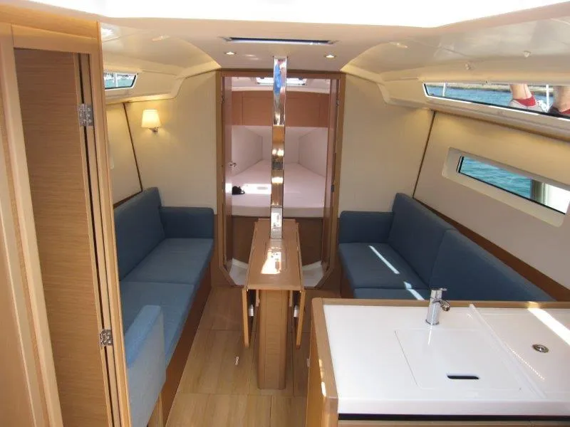 Slide: The Image of Interior of 2025 Jeanneau Sun Odyssey 350 yacht, featuring modern seating and sleek design. - 12