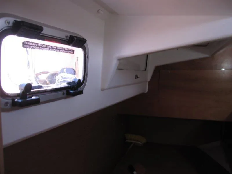 Slide: The Image of Interior cabin view of 2025 Jeanneau Sun Odyssey 350 sailboat, featuring a small window. - 20