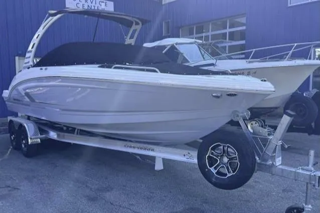 The Image of 2025 Chaparral 23 SSi OB boat on trailer, parked outside service center. - 0