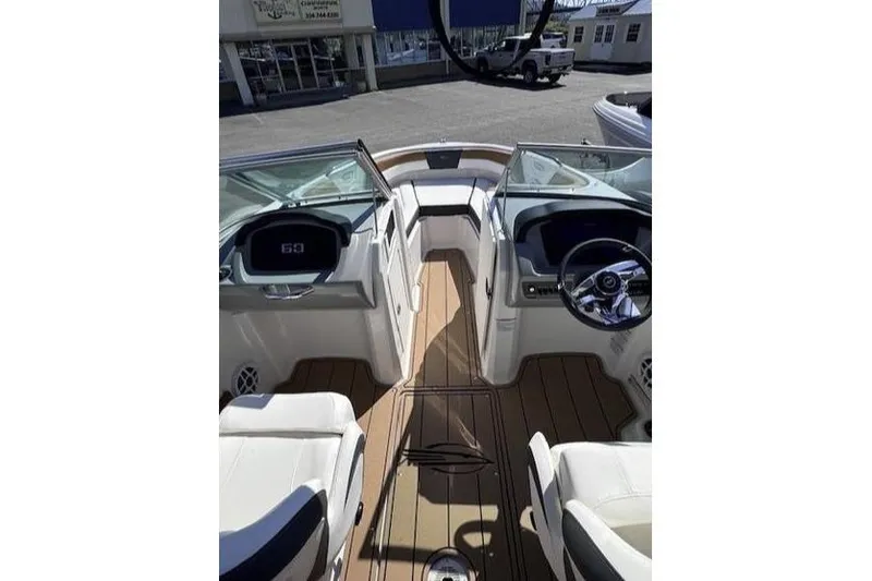 Slide: The Image of 2025 Chaparral 21 SSi boat interior with sleek design and modern dashboard. - 2