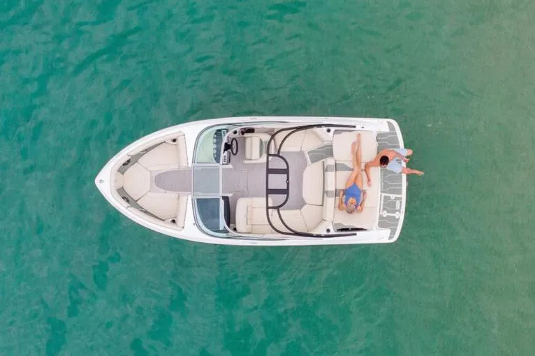 Slide: The Image of Manufacturer Provided Image: Aerial view of a 2026 Regal 2000 ES boat with two people relaxing on deck. - 2