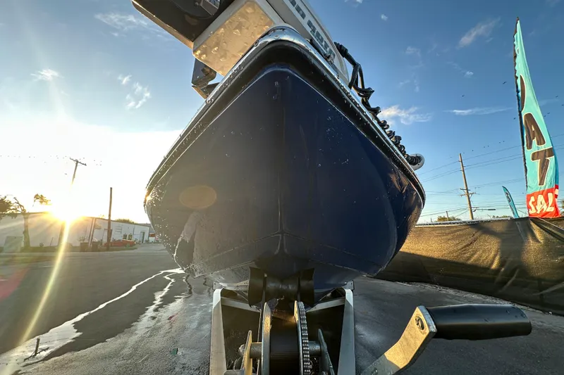 Slide: The Image of 2014 Skeeter SX2250 boat on trailer, parked outdoors under a partly cloudy sky. - 11