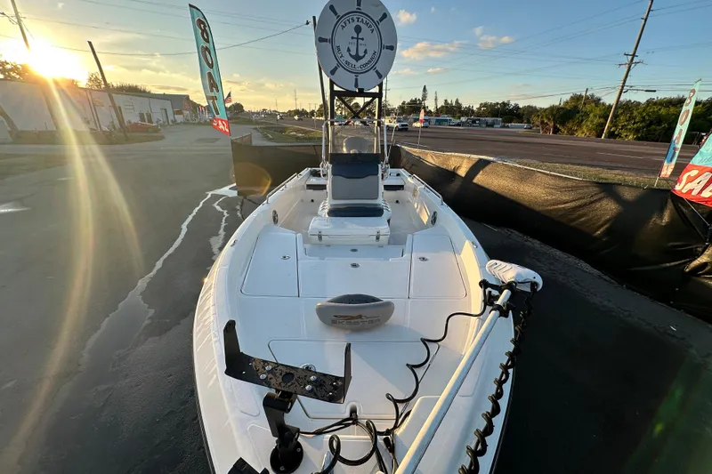 Slide: The Image of 2014 Skeeter SX2250 boat interior with console and seating, parked in a marina. - 16