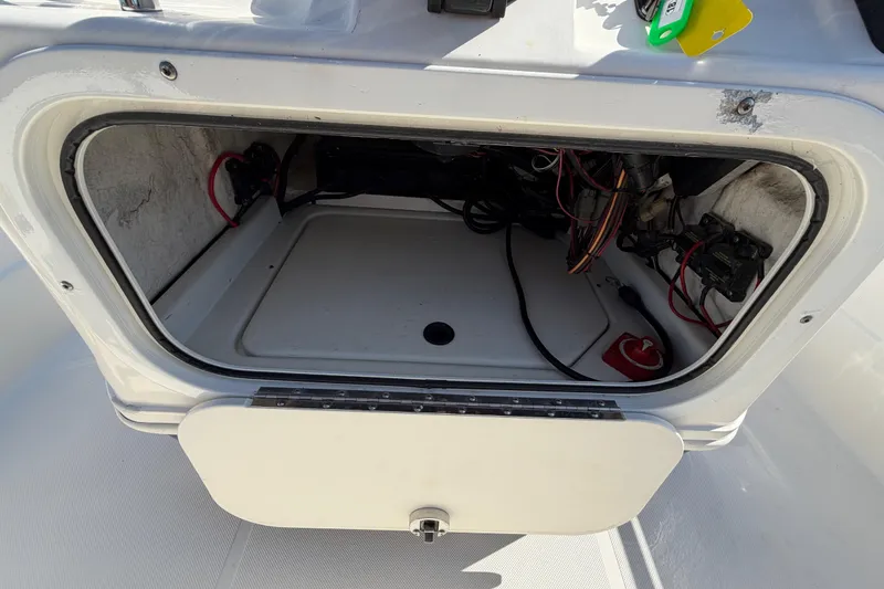 Slide: The Image of 2014 Skeeter SX2250 boat console with storage compartment and control panel. - 27