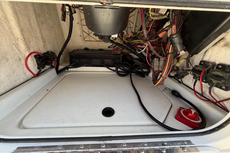 Slide: The Image of 2014 Skeeter SX2250 boat console storage compartment with wiring and equipment. - 28