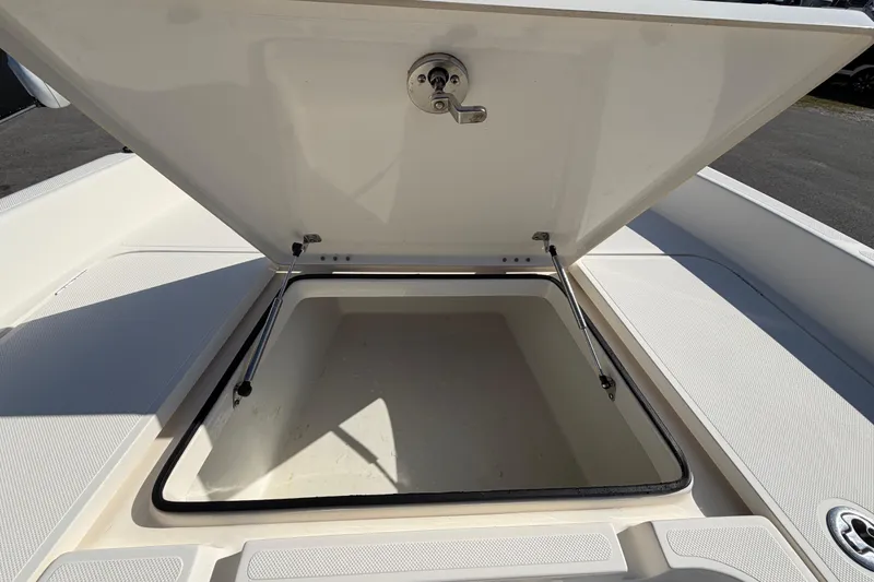 Slide: The Image of Open storage compartment of 2014 Skeeter SX2250 boat, featuring hydraulic struts. - 38